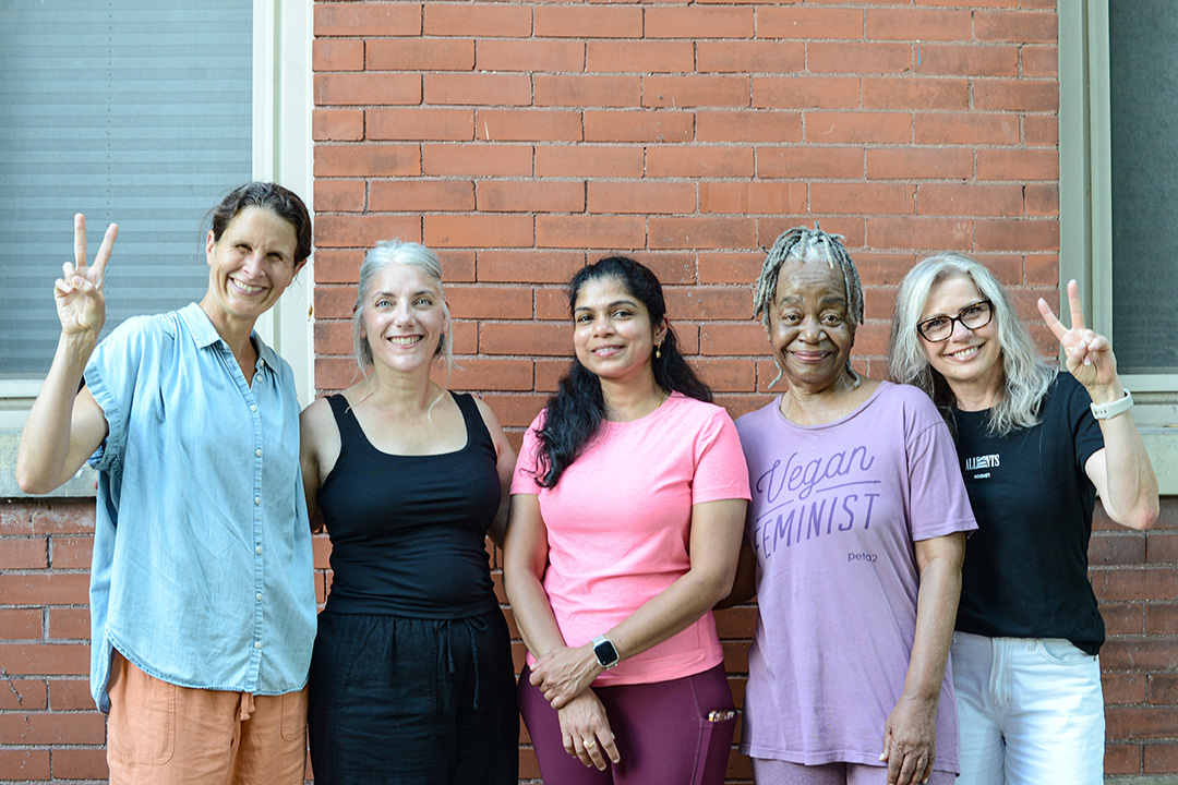 Five people smiling outside World Peace Yoga